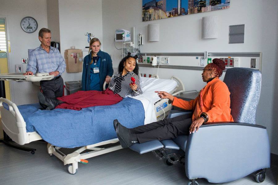 hospital room with patient and family