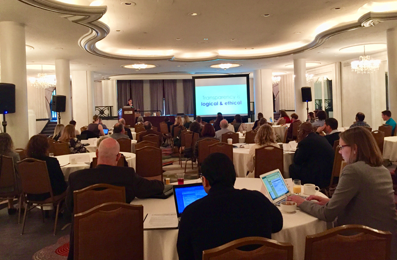Conference speaker and audience in ballroom